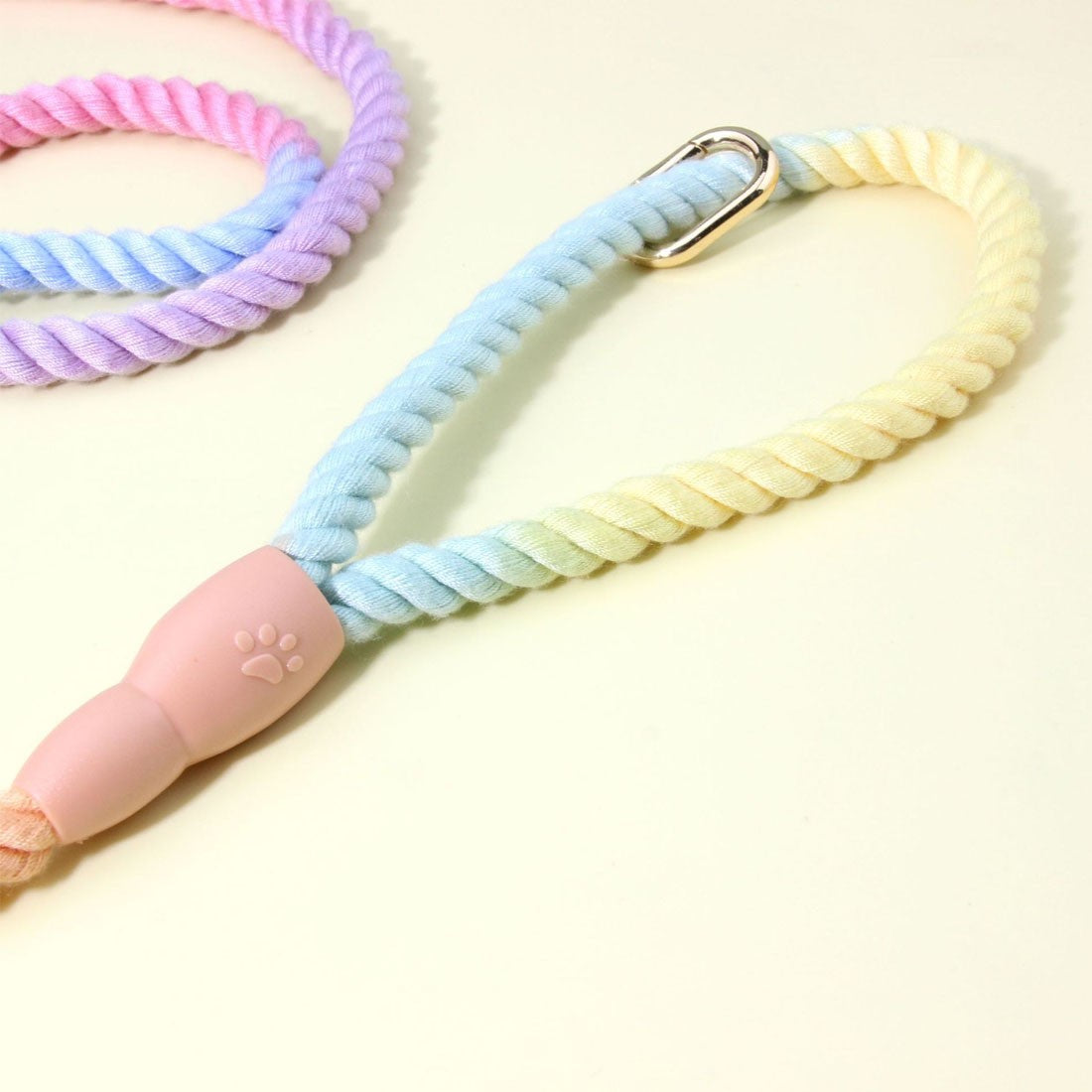 Rope slip lead close-up of a rope loop, gold-coloured metal ring and pink rubber sleeve with a paw print