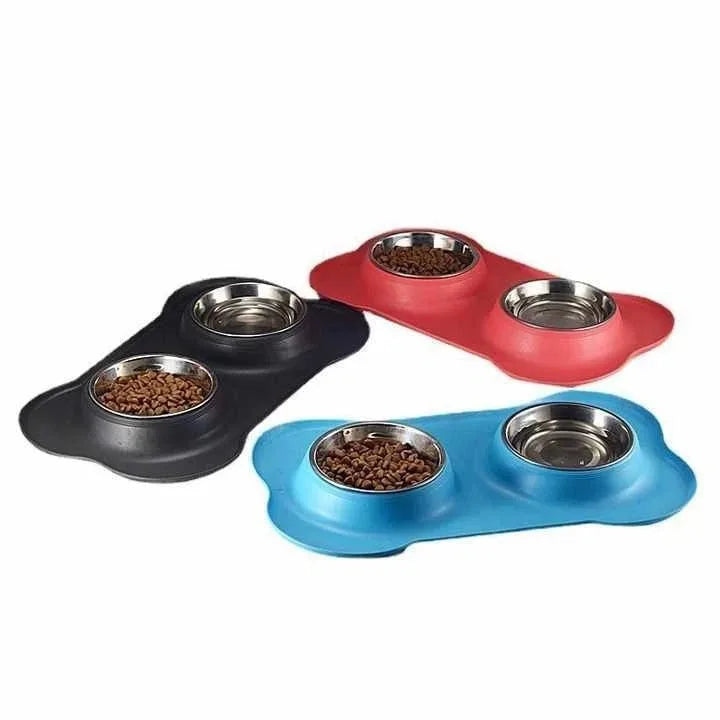 Black, red and blue bone-shaped silicone mats with steel bowls on a white background