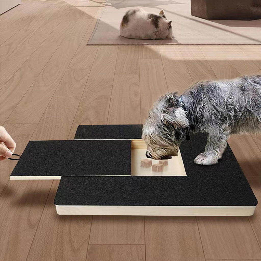 Dog nail scratch board with its treat compartment visible as a grey dog scratches it